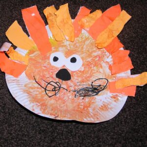 Easy toddler paper plate craft to make a lion's face ideal for jungle and circus themed crafts