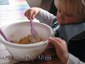 Toddler Mixing rice crispie cakes