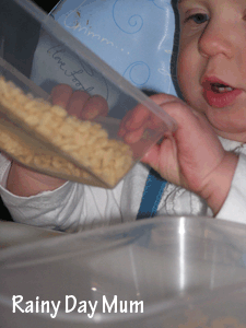 Baby developing fine motor skills with food play