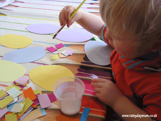 Toddler making Collage Easter Eggs
