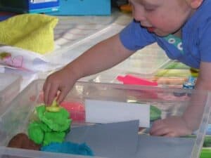 toddler playing at home in a quick and easy sensory bin retelling a nursery rhyme