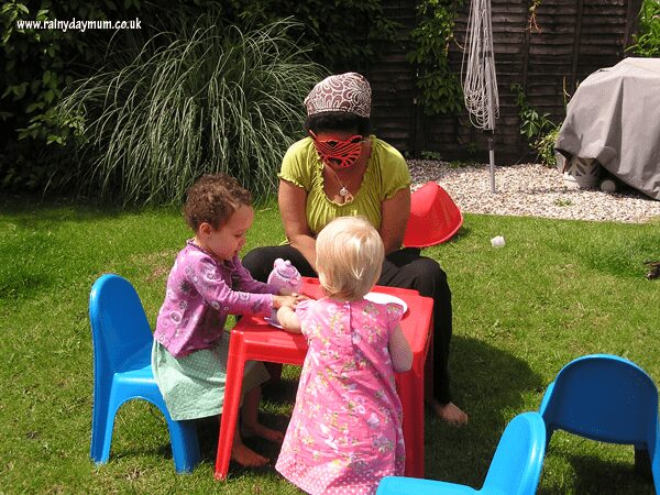 holding a tiger who came to tea playdate in garden with toddlers