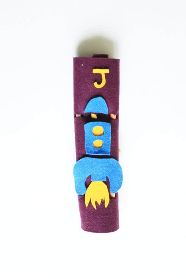An easy to make and decorate with your child no sew pencil roll from felt. This is a great project to make with your child for back to school!