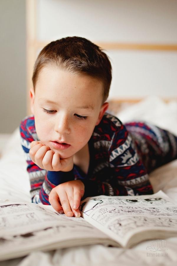 boy reading on his bed