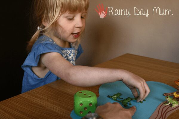 1, 2, and 3 fogs in the pond matching the 3 dots on the dice in this simple diy maths game for spring for toddlers and preschoolers