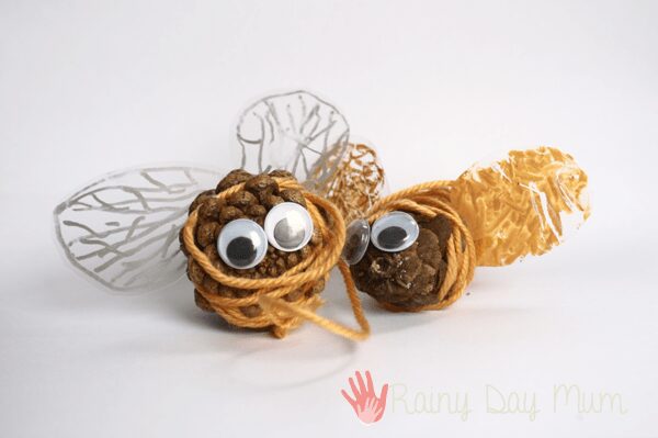 pinecone bumble bees with yellow yarn and junk box plastic wings