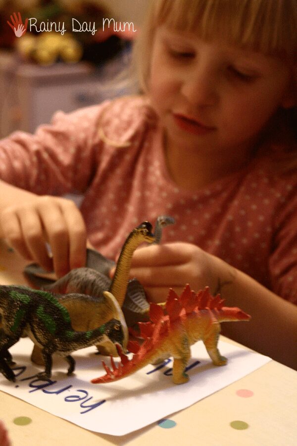 Classification and sorting of dinosaurs working on science and math knowledge with preschoolers