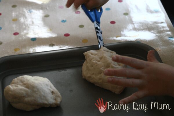 cutting into bread dough to make spikes for hedgehog bread