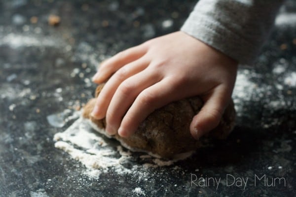 rolling out gingerbread dough on a lightly floured work surface in the kitchen