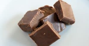 Simple 4 ingredient Fudge recipe that you can make in your slow cooker or crockpot. So easy even the kids can do it!