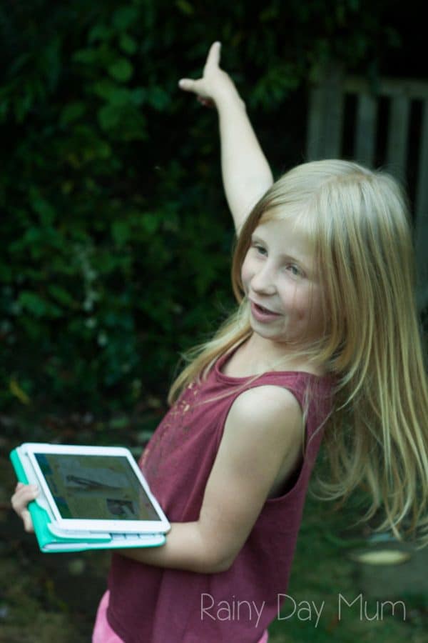 Preschooler spotting birds in her garden and recording them on the RSPB app