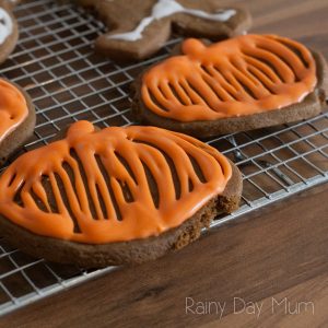 gingerbread halloween cookies with royal icing in the shape of pumpkins that the rainy day kids have cooked
