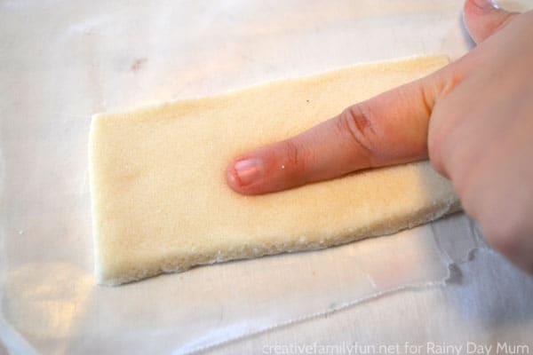 picture of child's finger in salt dough to create a fingerprint ornament for the Christmas Tree