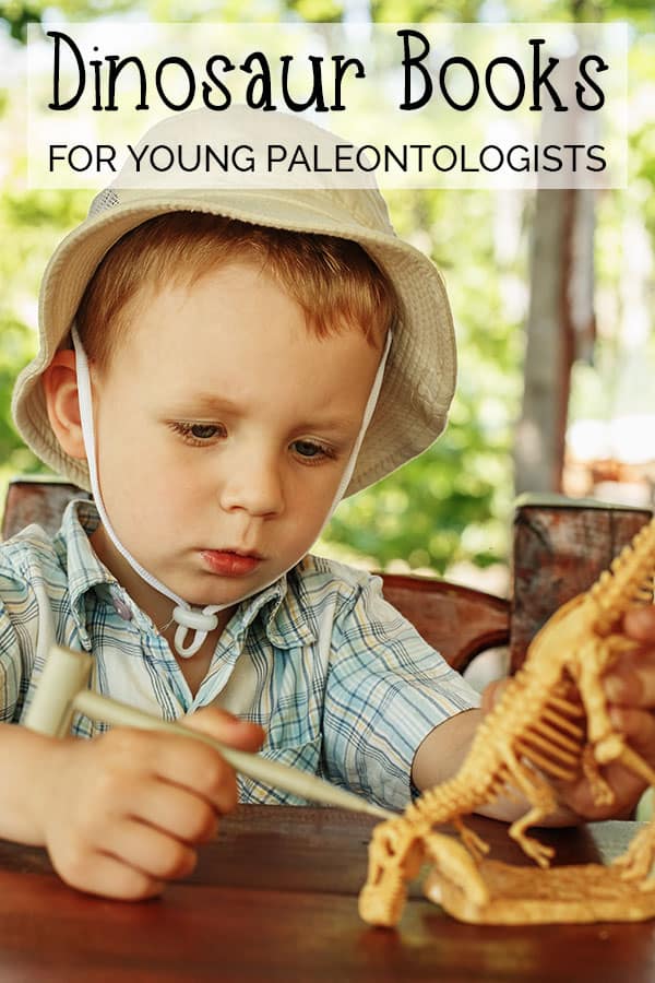 Boy looking at a model of a dinosaur skeleton with a small chisel, wearing an "explorers" hat, text reads Dinosaur Books for Young Paleontologists