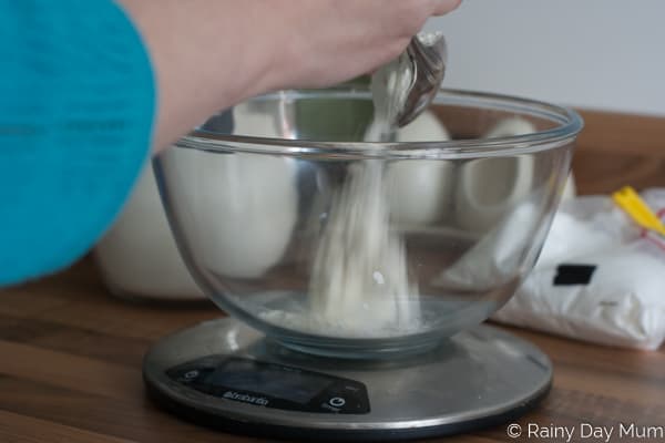 weighing out flour on electronic scales to make salt dough