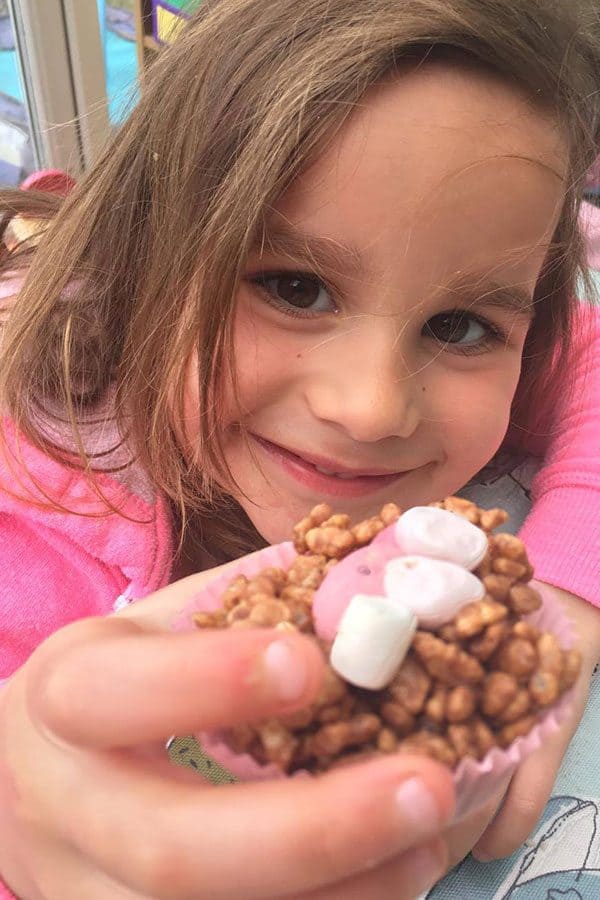 preschooler holding a chocolate nest in her hand
