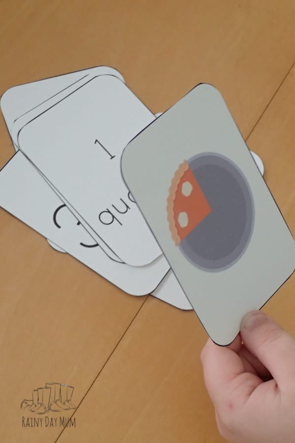 child holding a 1/4 of pumpkin pie flash card from a printable pumpkin pie fractions set