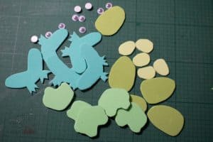 parts of frog puppets cut out ready to assemble