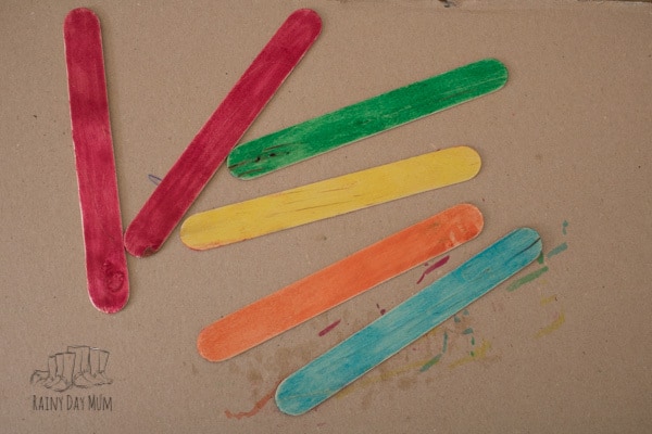 Simple shape activity for toddlers and preschoolers inspired by the classic fairy tale Three Little Pigs using craft sticks to make shape and colour houses.