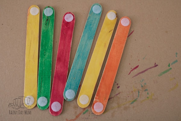 Simple shape activity for toddlers and preschoolers inspired by the classic fairy tale Three Little Pigs using craft sticks to make shape and colour houses.
