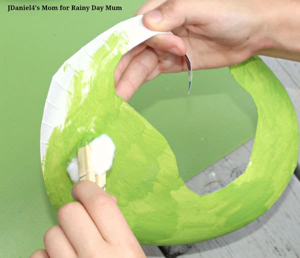 painting a green dinosaur paper plate