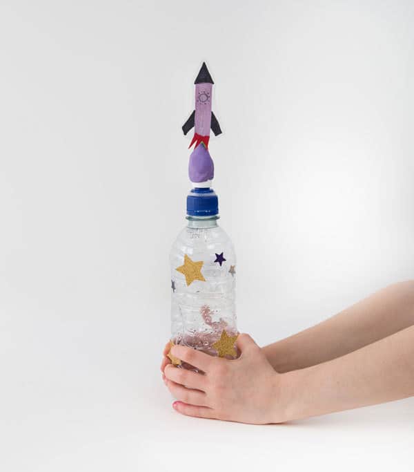 Child holding a homemade space rocket