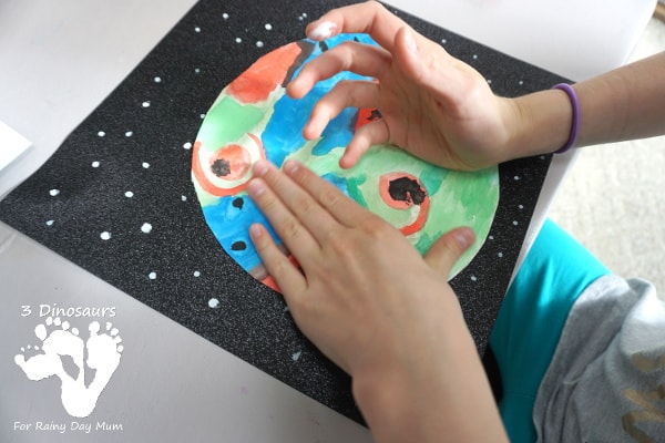 Get creative with this space-themed art project for kids inspired by literature to create an imaginative set of watercolour planets.