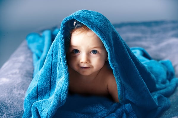 Baby at 7-months-old playing peek a boo with a towel