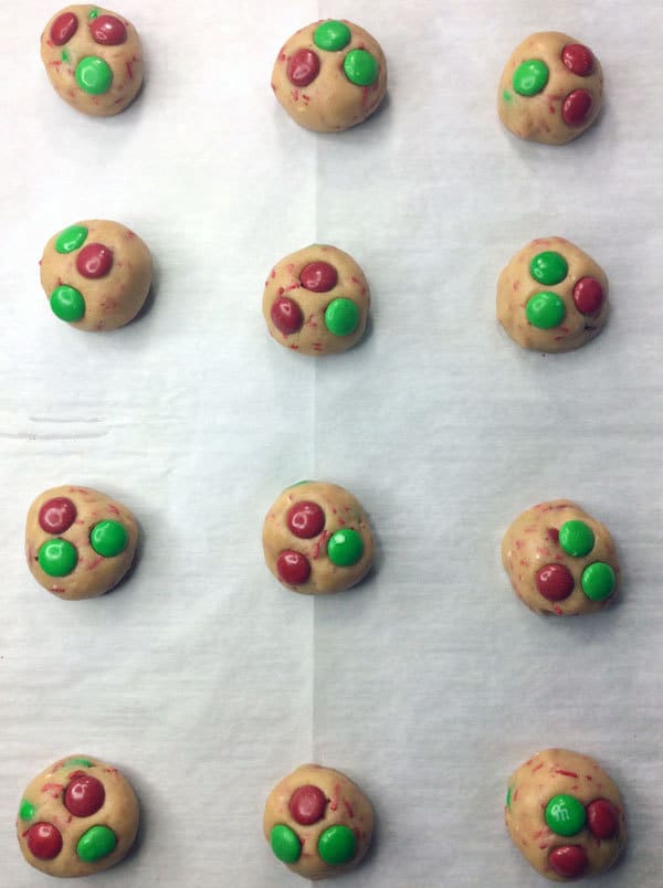 Ice-cream scoop cookie dough and place the m&ms on top for these easy Christmas Cookies to cook with Kids