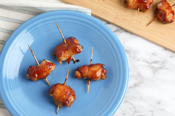 Wrap chicken pieces marinaded in homemade fajita seasoning with smoked bacon and coat with BBQ sauce a simple party appetiser that everyone will love
