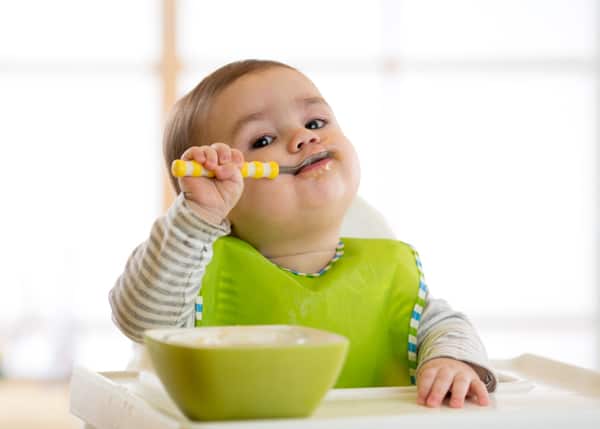 11-month-old baby feeding themselves new foods