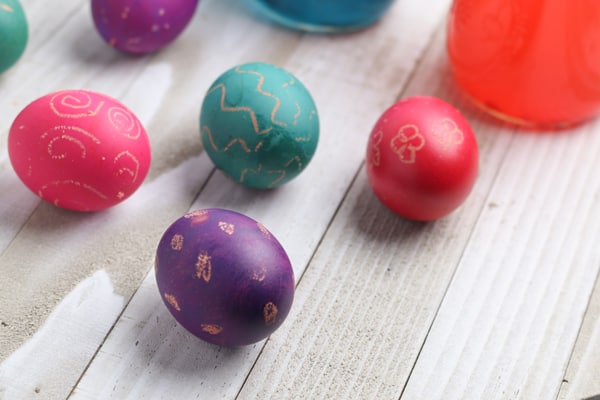 Simple dyed Easter eggs with crayon resist designs decorated by the kids