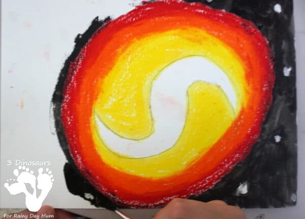 painting using water colours over an oil pastel galaxy reveals the white and colours formed