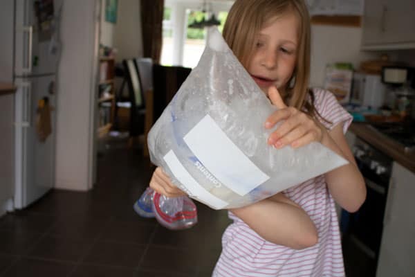 girl doing the ice-cream in a bag experiment