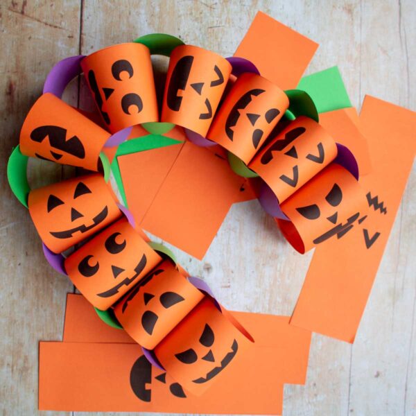 homemade halloween paper chains with free printable jack-o-lantern faces to make with kids