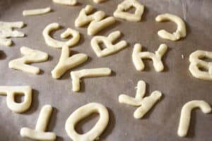 alphabet cookies on a baking tray