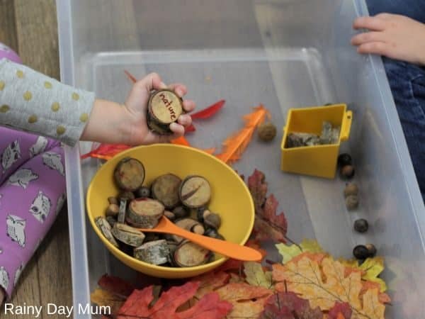 kids playing in a sensory bin using it to share what they are thankful for