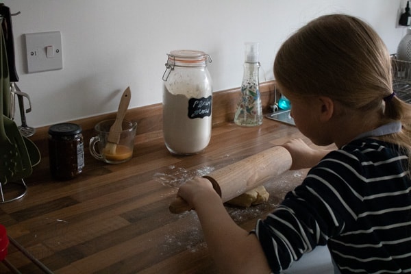 child rolling pastry