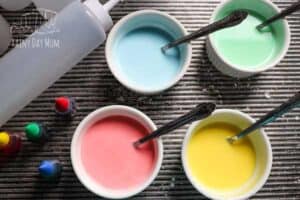 bowls with sidewalk chalk in ready for kids to paint with