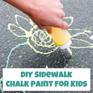 DIY Sidewalk chalk paint being used to draw a sunflower on the drive