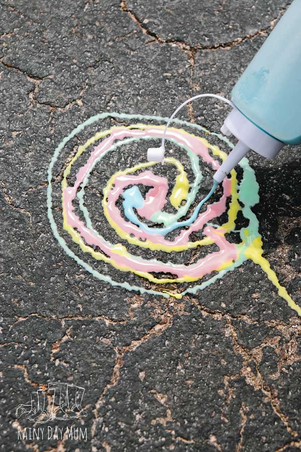 child making patterns with sidewalk chalk paint made at home