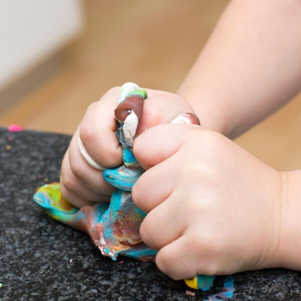 sensory play with playdough and other materials for kids, kids hands moulding playdough mixed up colours