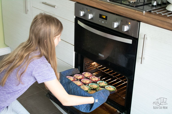 putting muffins in the oven cooking with kids