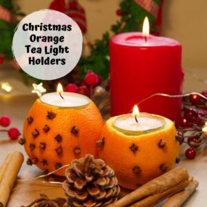 2 orange pomander tea light holders with a candle, pine cones and cinnamon sticks made by kids as an easy Christmas Craft