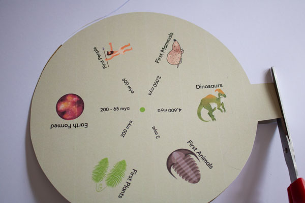 cutting out the geological time clock for young kids from a free printable