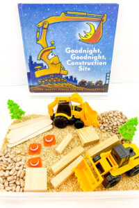 invitation to play, goodnight goodnight construction site themed sensory bin set up with brown rice, pinto beans, trucks and building blocks
