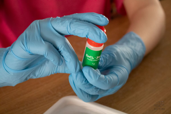 mixing chemicals safely with gloves provided in the subscription box from Mel Science Chemistry kits
