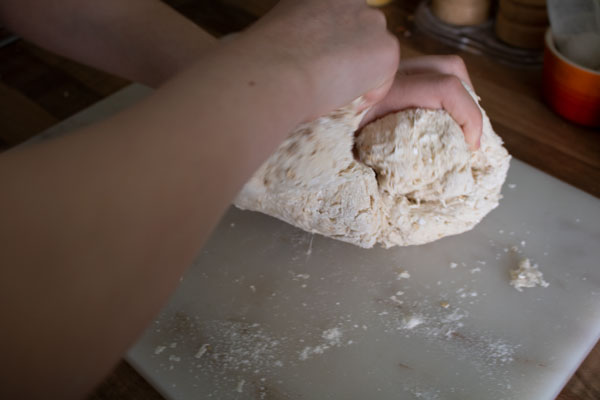 kneading a Norse Soda bread on a granite board in the kitchen for a History Unit Study on Vikings