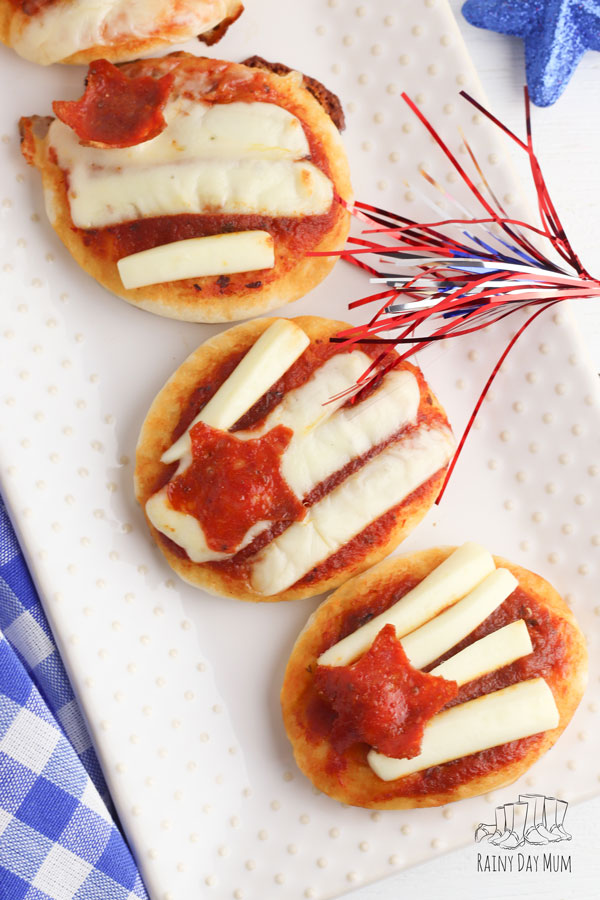 mini flag pizzas cooked by the kids, the cheese makes the stripes and there is a pepperoni star a simple snack or appetizer for 4th of July that the kids can cook themselves