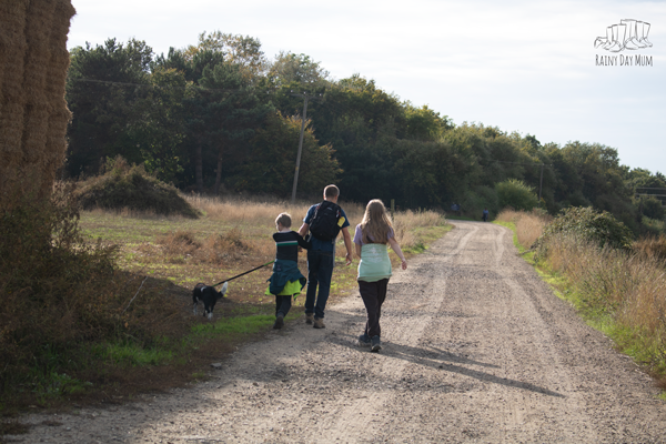 family out for a hike with the dog across the fields and farms on an orienteering adventure